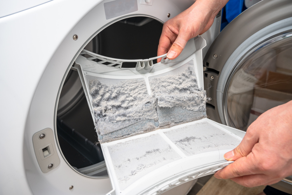 Lint buildup inside a dryer lint filter showing a common cause of dryer fire risks and the need for regular dryer maintenance services.